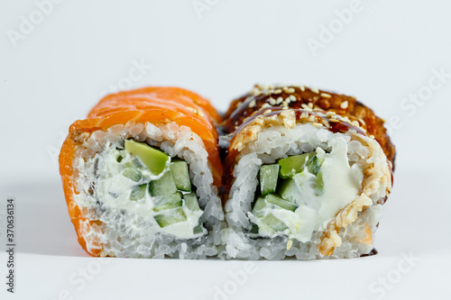 Sushi assorted. Sushi roll with avocado, cucumber. Sushi roll with salmon and caviar. Sushi roll with tuna and caviar. On a light background. Japanese food. View from above