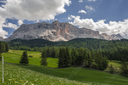 East face of Sasso di Santa Croce mountain range in eastern Dolomites, overlooking Badia valley, the vertical wall of 900 meters & Mount Cavallo, seen from Roda de Armentara, South Tirol, Italy. 