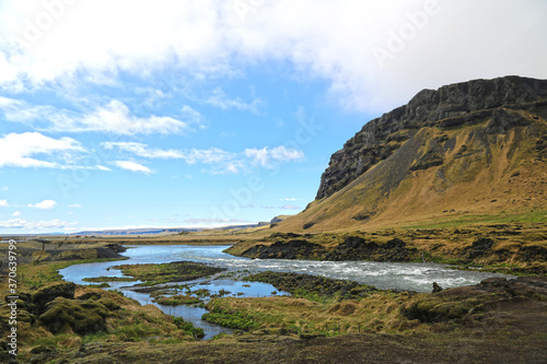 Beautiful green and yellow mountainside and river in iceland 