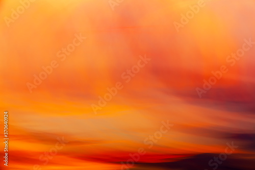 Clouds on sunset shooted with long shutter speed and wave camera motion. Abstract background