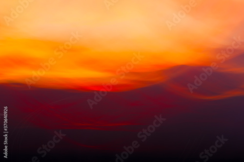 Clouds on sunset shooted with wavy motion. Abstract background