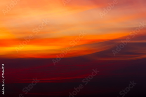 Blurry colorful sky in sunset time with wavy camera motion. Abstract background