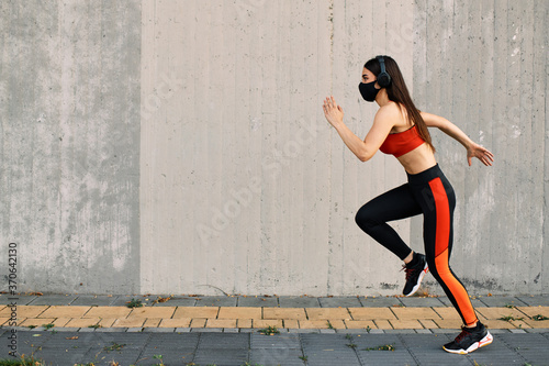 Woman running wearing mask for protection