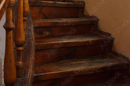 Shabby steps of old wooden staircase with selective focus