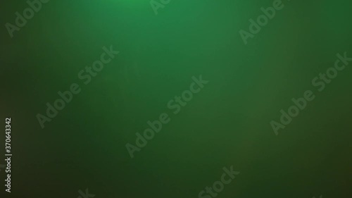 Close up of green spotlight beam flaring