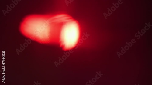 Close up of red spotlight beam flaring