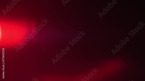 Close up of red spotlight beam flaring