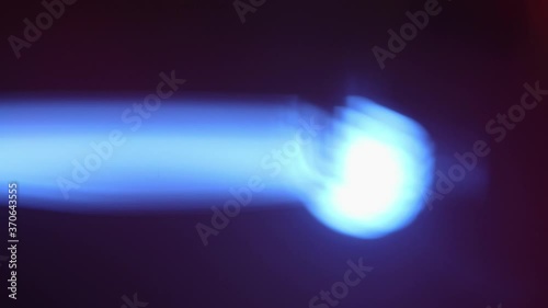 Close up of blue spotlight beam flaring