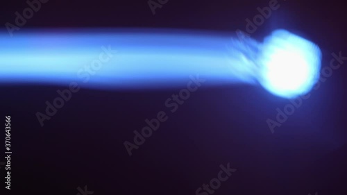 Close up of blue spotlight beam flaring