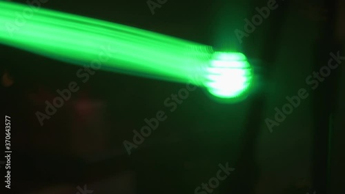 Close up of green spotlight beam flaring