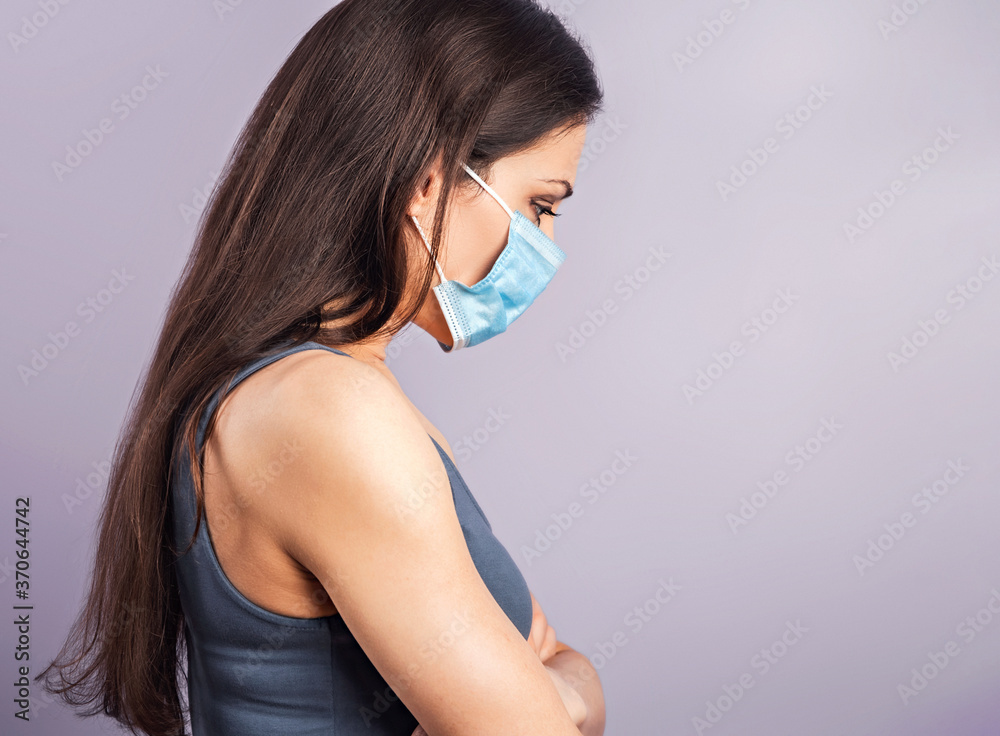 Female in respiratory blue mask. Serious woman looking down. Cold, flu, virus, tonsillitis, respiratory disease, quarantine, epidemic concept portrait. Beautiful caucasian woman with empty space. Female in respiratory blue mask. Serious woman looking down. Cold, flu, virus, tonsillitis, respiratory disease, quarantine, epidemic concept portrait. Beautiful caucasian woman with empty space.