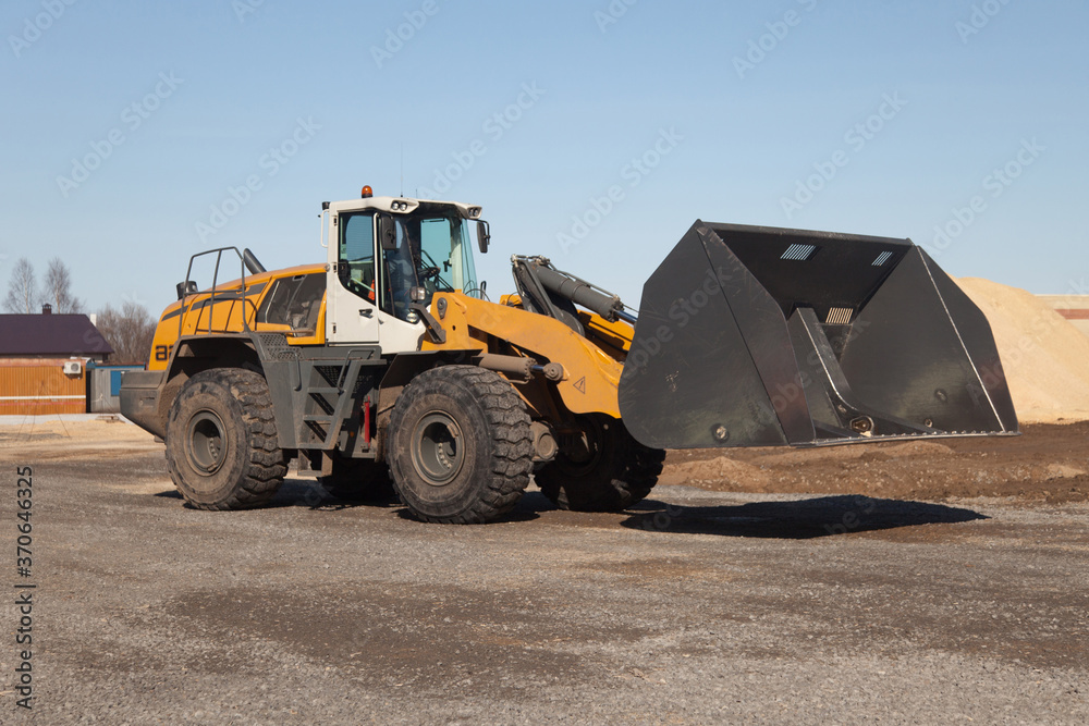 yellow industrial bulldozer at sawmill