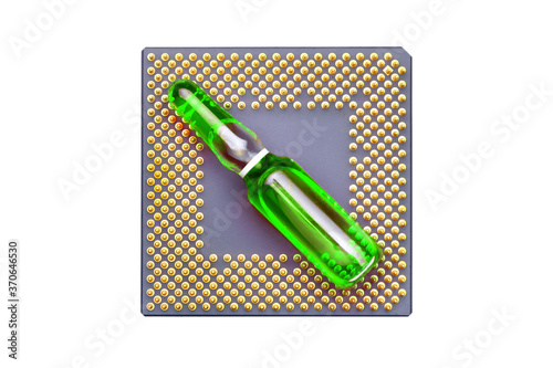 glass ampoule with green fluid for vaccination implantation cpu chip implantation for surveillance and verification human, concept on conspiracy theology theme of coronavirus top view.