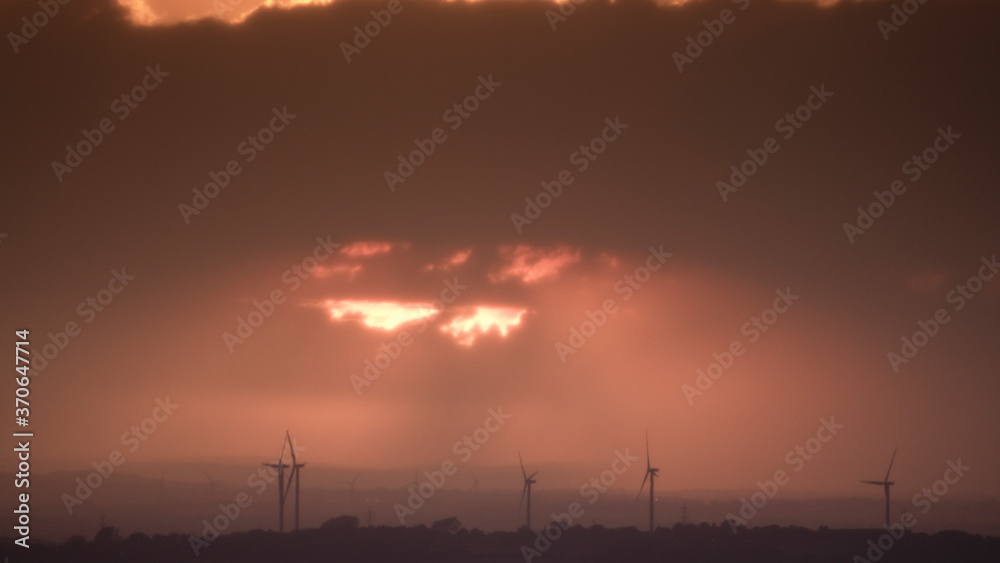Sunset with wind turbines in the distant countryside, North Yorkshire, United Kingdom