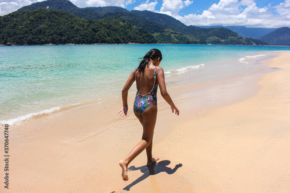 teenager running on the beach sand in brazil