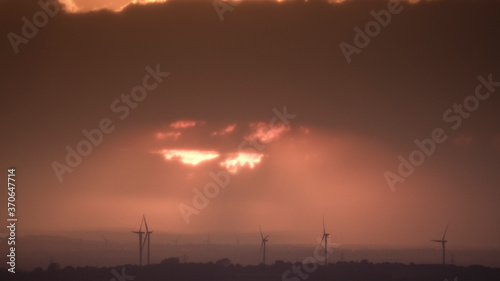 Sunset with wind turbines in the distant countryside, North Yorkshire, United Kingdom