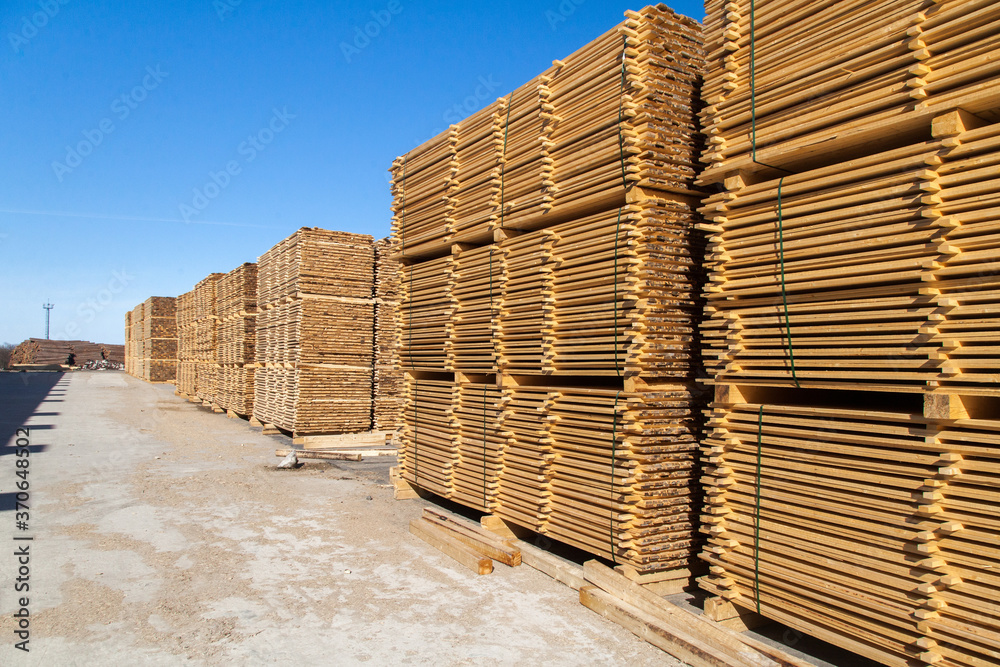 A pallet of boards in an industrial sawmill warehouse