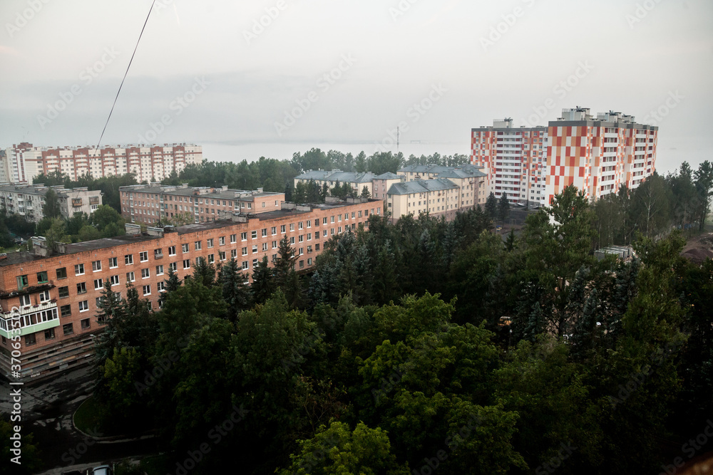 Foggy morning landscape in a residential area with apartment buildings