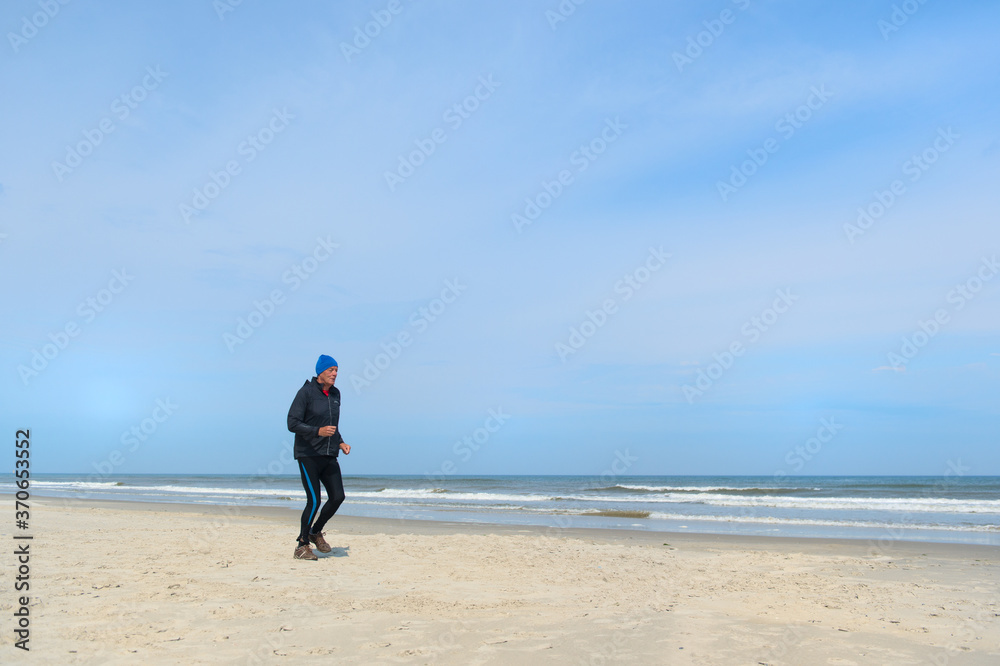 Senior man running at the beach