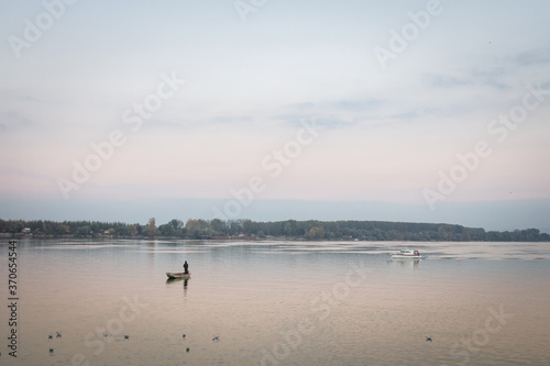Fisherman boat fishing on the Danube river on his rowing boat during a warm autumn afternoon in Zemun  a northern district of Belgrade  capital city of Serbia.