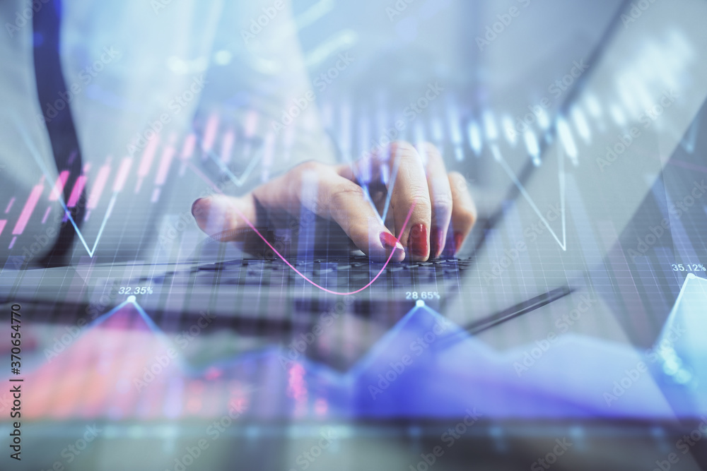 Double exposure of businesswoman hands typing on computer and financial graph hologram drawing. Stock market analysis concept. Double exposure of businesswoman hands typing on computer and financial graph hologram drawing. Stock market analysis concept.
