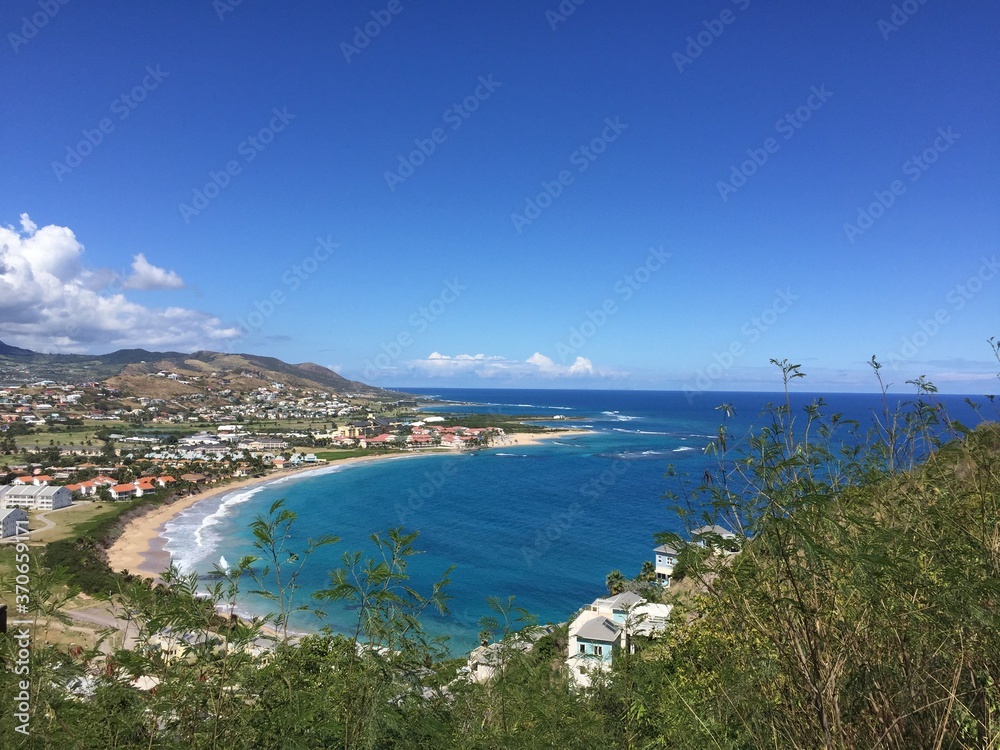 Landscape view of lush tropical coastline under blue skies