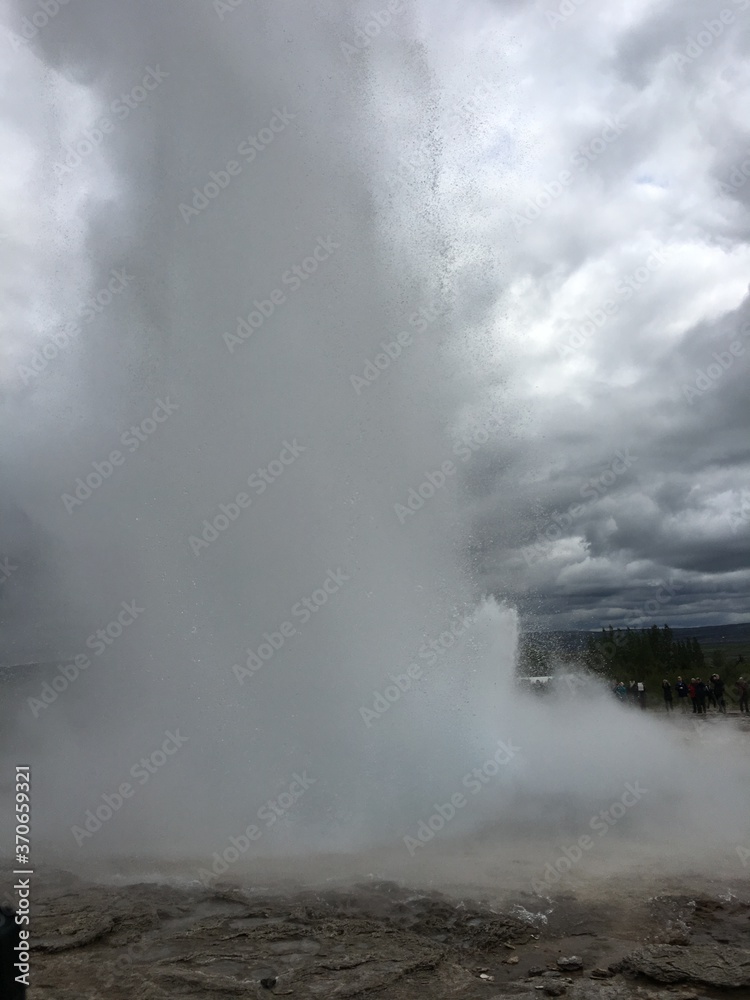 Active natural geyser under cloudy skies