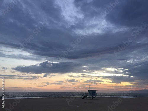 Landscape view of lifeguard tower on empty sand beach at sunset © Michael