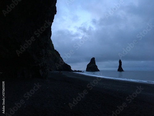 Landscape view of rocky beach coast at dusk 