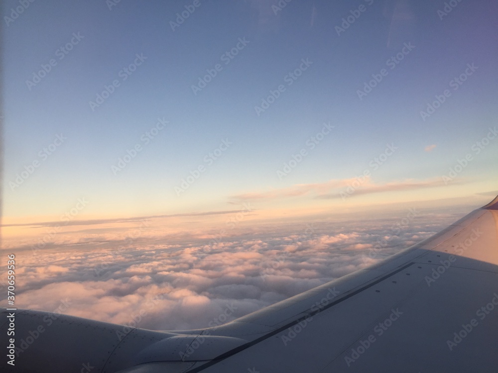 Aerial view of sunset clouds from airplane window