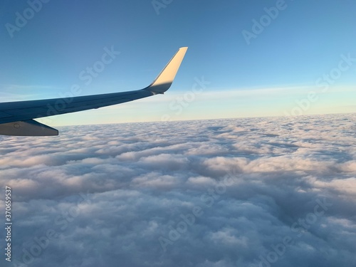 Aerial view of sunrise clouds from airplane window
