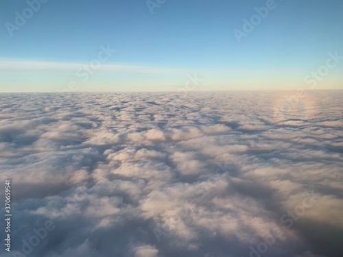 Aerial view of sunset clouds from airplane window