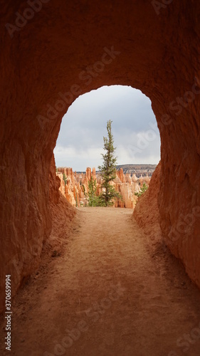 Rock tunnel on edge of canyon in Bryce Canyon National Park, Utah, United States