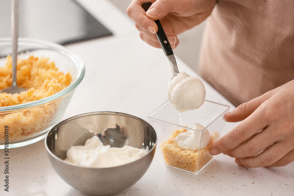 Woman preparing delicious cupcake in jar Woman preparing delicious cupcake in jar