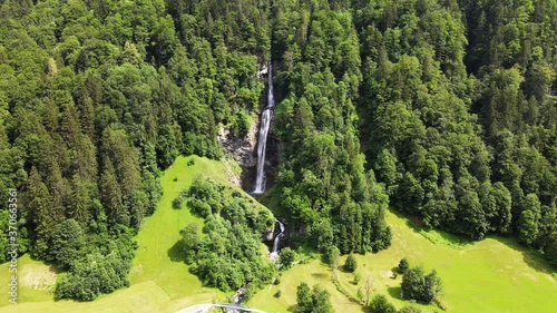 Beautiful rotating aerial cinematic shot of Diesbachfall in Glarus, Switzerland photo