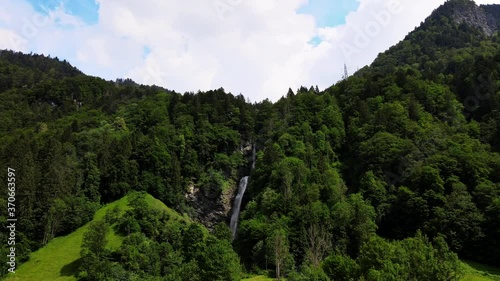 Aerial cinematic rising crane shot of Diesbachfall in Glarus, Switzerland photo