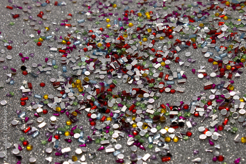 Colorful sequins on a Silver glitter background Colorful sequins on a Silver glitter background