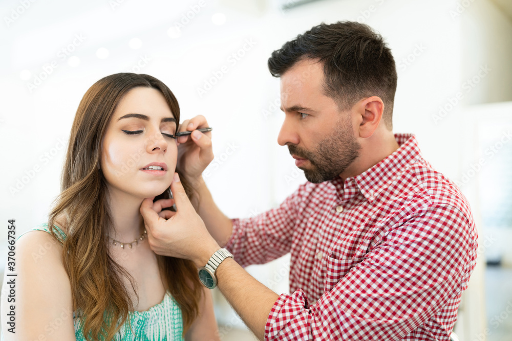 Artist With Doing Makeup Of Female Client Artist With Doing Makeup Of Female Client