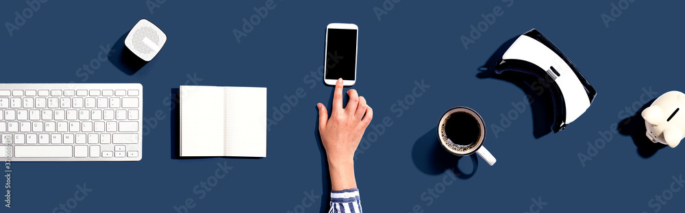 Person using a smartphone with a VR and a computer keyboard Person using a smartphone with a VR and a computer keyboard