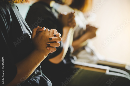 Three people pray and praising God together