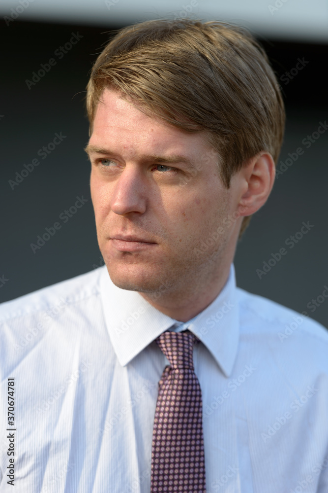 Handsome Scandinavian businessman with blond hair outdoors