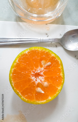 half orange fruit on cutting board for squeezing