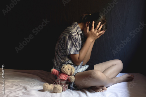 Sad girl sitting in room. human trafficking concept.