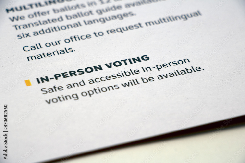 Closeup paper with 'In-Person Voting' info