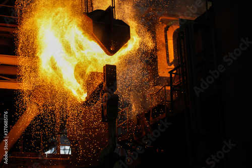 Steel production in electric furnaces. Sparks of molten steel. Electric arc furnace shop EAF. Metallurgical production, heavy industry, engineering, steelmaking