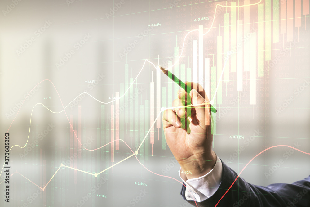 Man hand with pen working with abstract virtual financial graph on blurred office background, financial and trading concept. Multiexposure Man hand with pen working with abstract virtual financial graph on blurred office background, financial and trading concept. Multiexposure