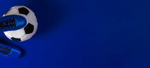 Sport soccer football banner background. Soccer ball under soccer players feet on blue background