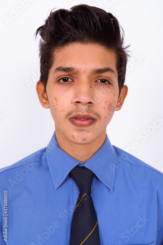 Portrait of young handsome Indian teenage boy as businessman