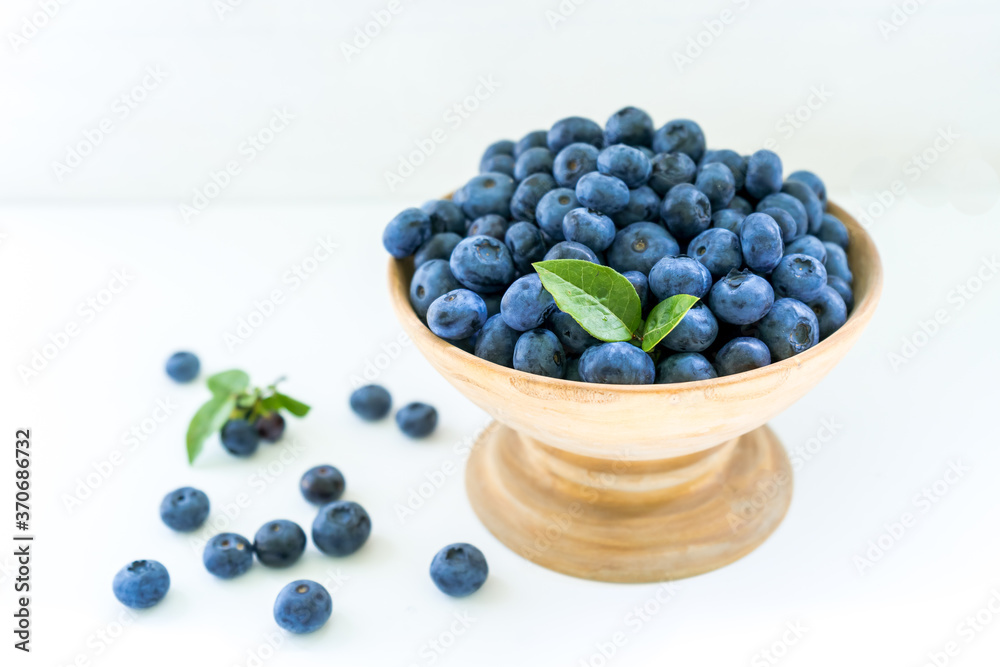 Blueberries on the table in a wooden cup Blueberries on the table in a wooden cup