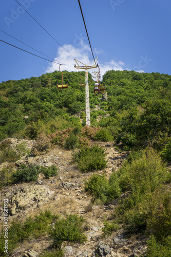 Riding the Chair Lift through the Forest of the High of "The Old Mountan" on Balkan peninsula. Trees on the Hills surrounding in the Mountains of Sliven, Bulgaria.